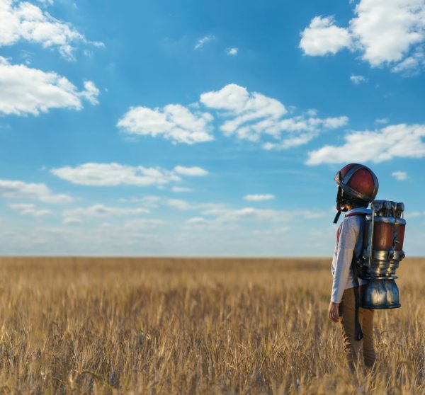 Little boy with a backpack and helmet outdoors