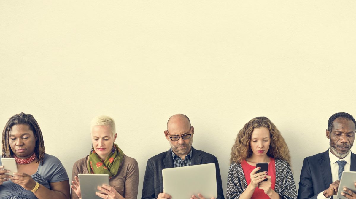 Diverse Group of People Community Togetherness Technology Sitting Concept